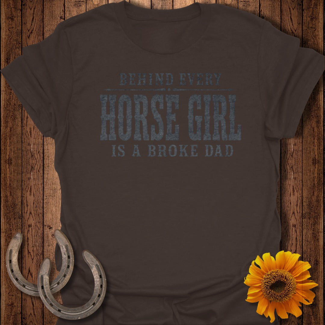 Brown t-shirt with text "BEHIND EVERY HORSE GIRL IS A BROKE DAD."