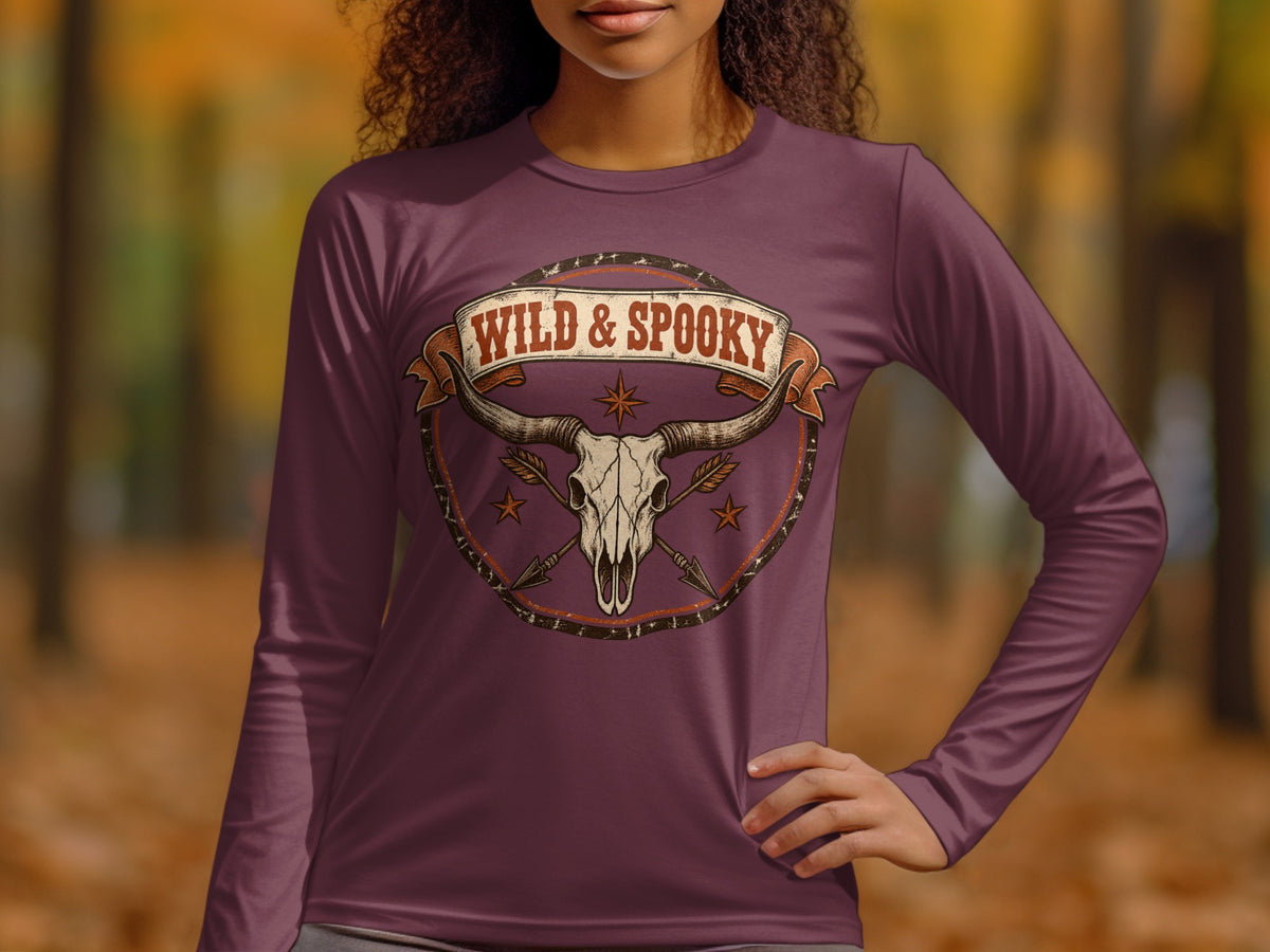 Long-sleeve shirt with a bull skull, arrows, and "WILD & SPOOKY" text graphic.