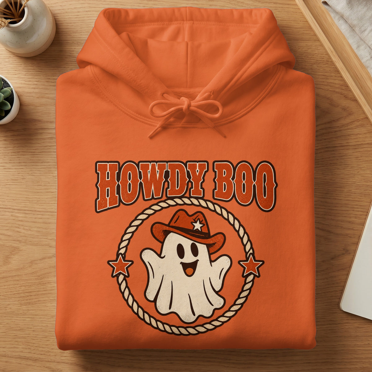 Orange hoodie with "Howdy Boo" text and a cowboy ghost graphic.