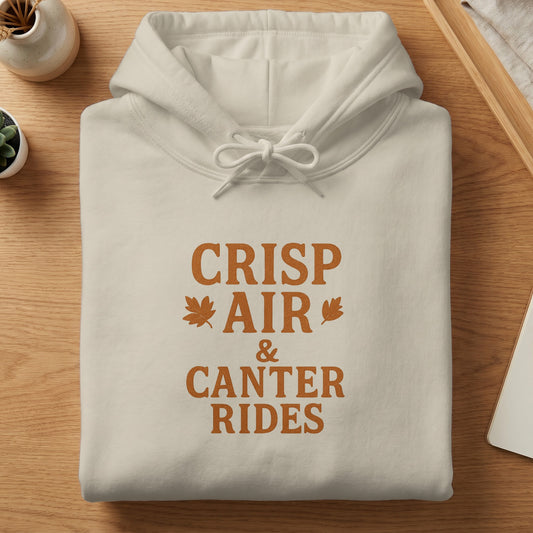 Cream hoodie with "Crisp Air & Canter Rides" text and autumn leaf graphics.