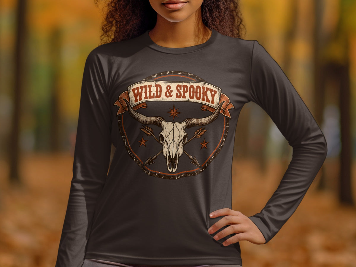 Dark long-sleeve shirt with a bull skull, arrows, and banner reading "WILD & SPOOKY".