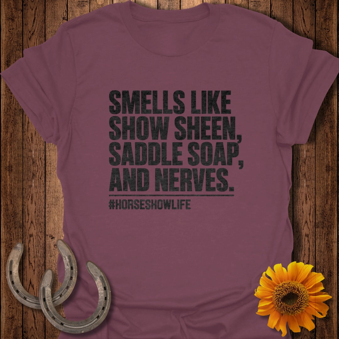 Maroon t-shirt with black text that reads SMELLS LIKE SHOW SHEEN, SADDLE SOAP, AND NERVES.
