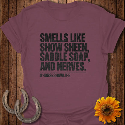 Maroon t-shirt with black text that reads SMELLS LIKE SHOW SHEEN, SADDLE SOAP, AND NERVES.