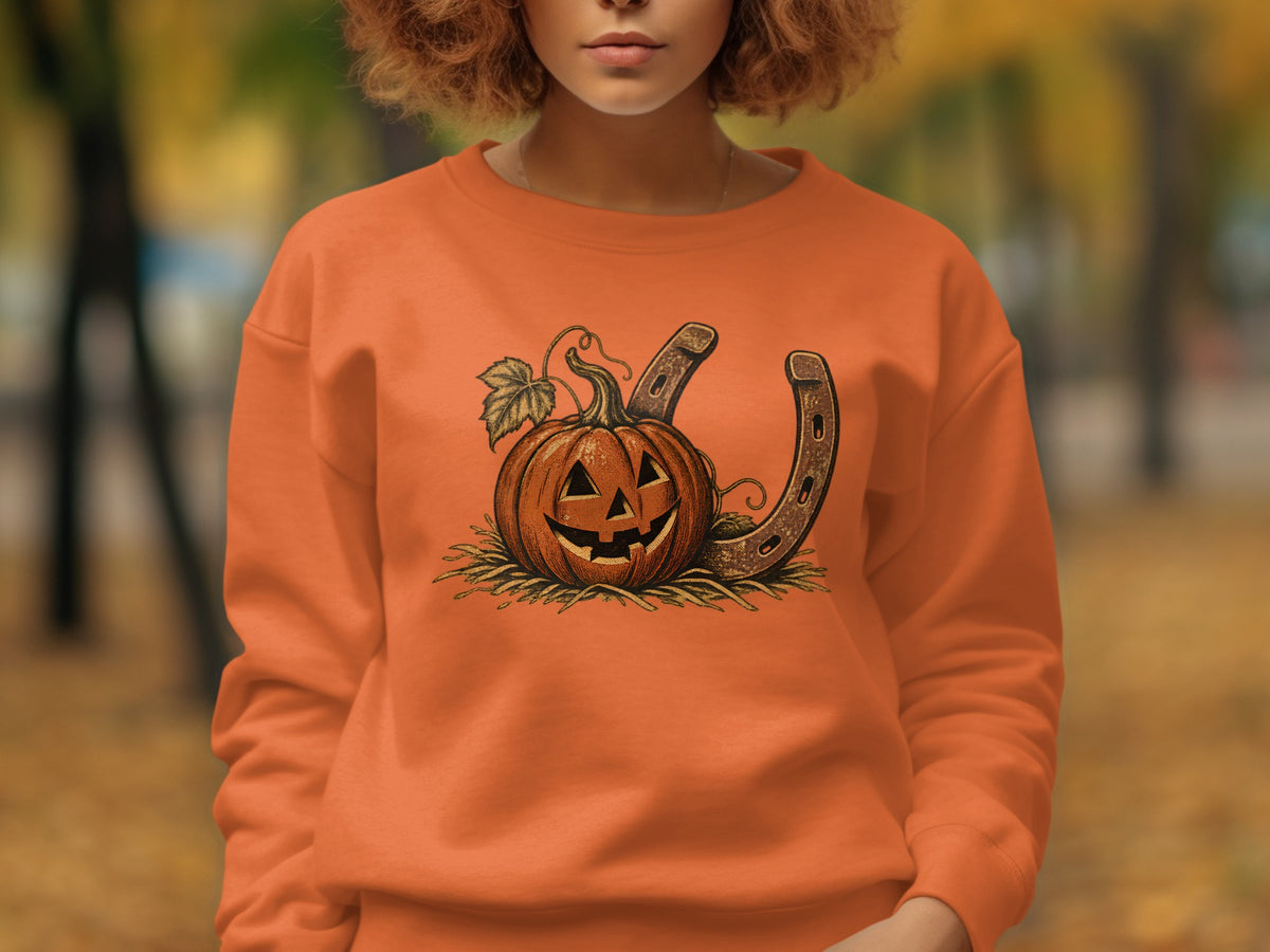 Orange sweatshirt with a jack-o'-lantern and horseshoe graphic.