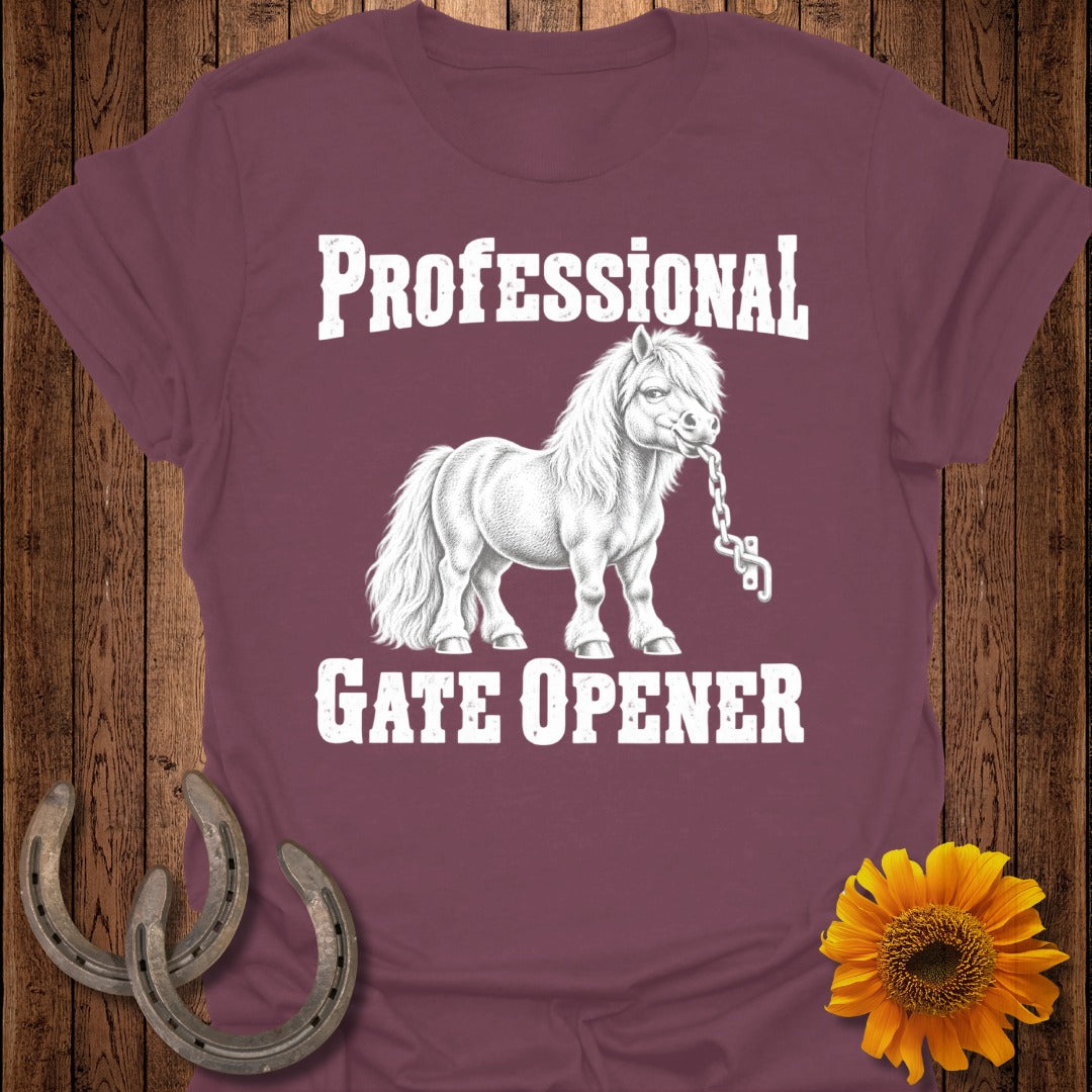 Maroon t-shirt with white text and drawing of a pony holding a chain and text "PROFESSIONAL GATE OPENER".