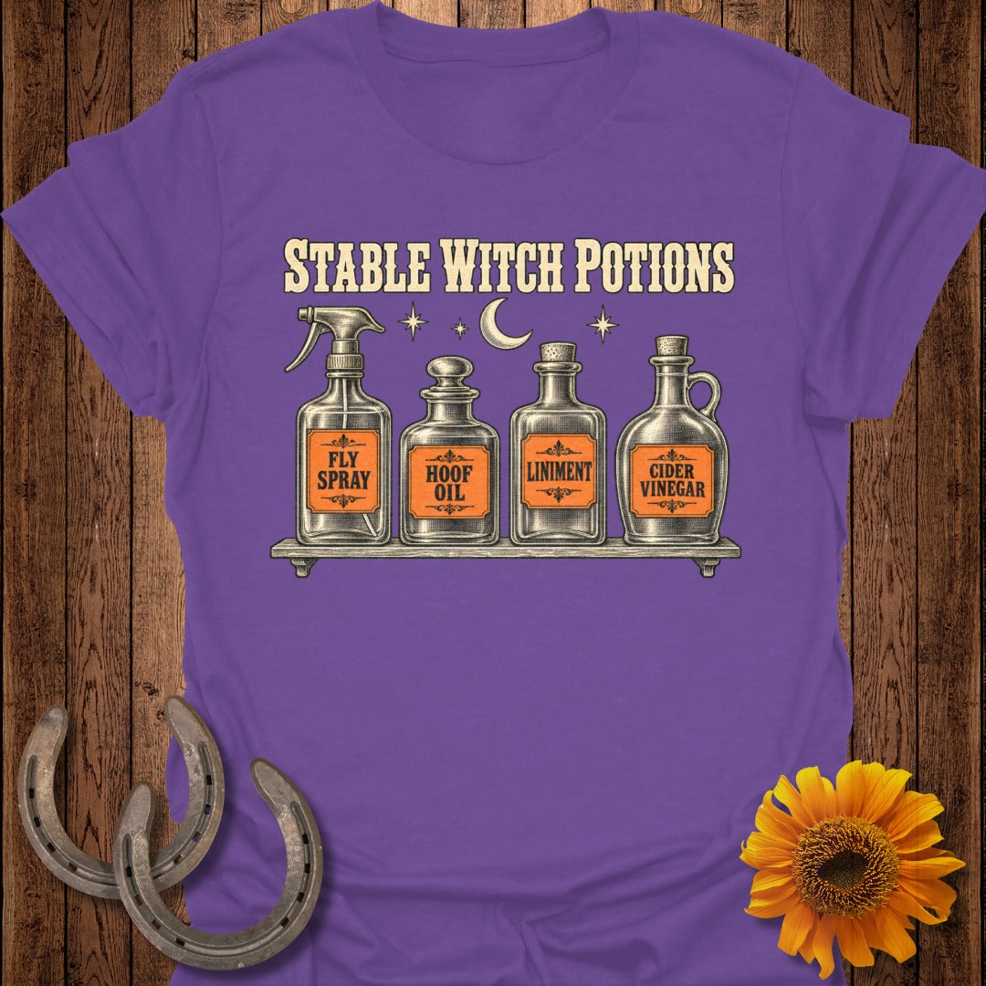 Purple t-shirt with "Stable Witch Potions" text and four potion bottles.