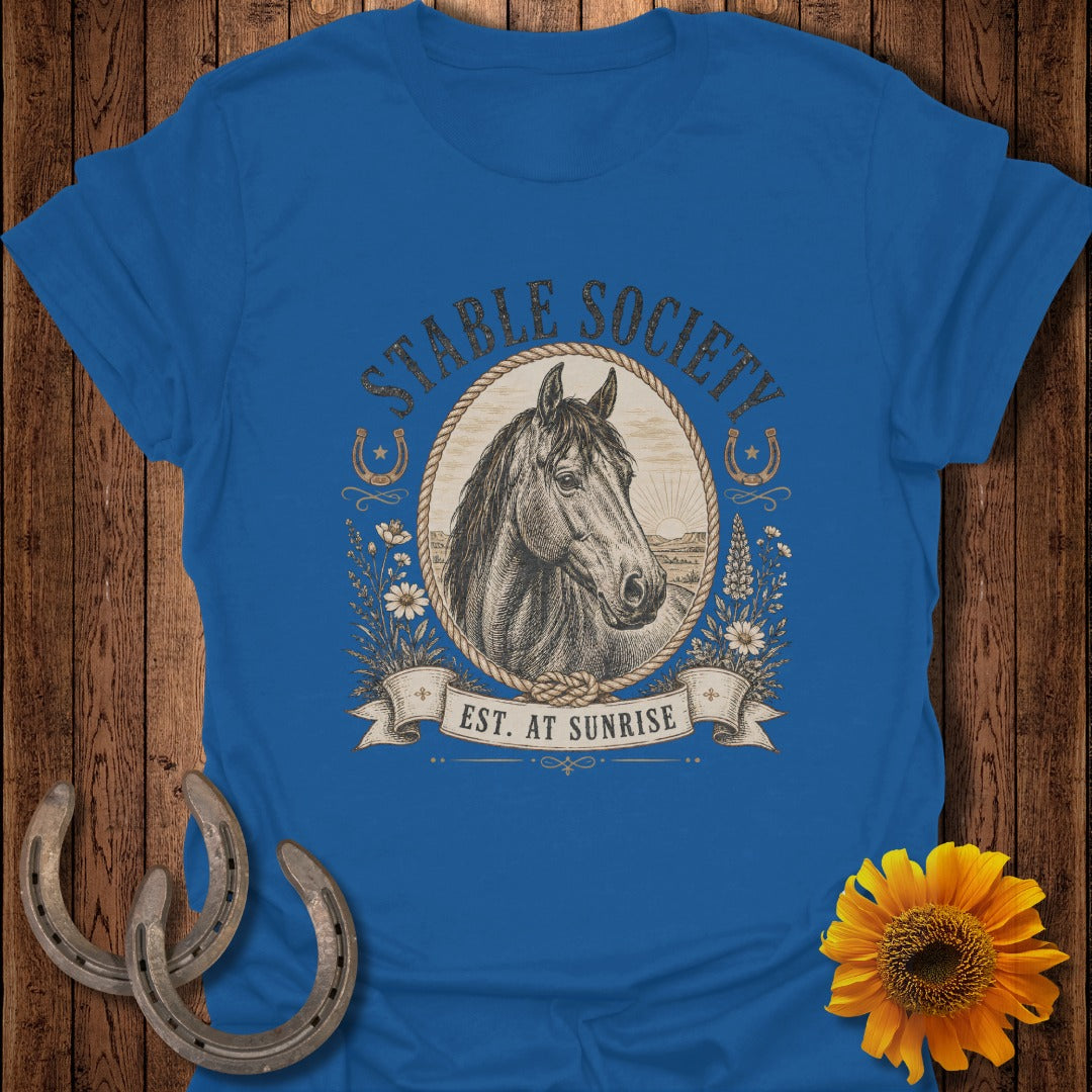 Blue t-shirt with oval graphic of horse, text "STABLE SOCIETY EST. AT SUNRISE".
