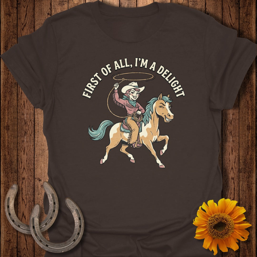 Brown t-shirt with cartoon cowgirl riding a horse, "First of all, I'm a delight."