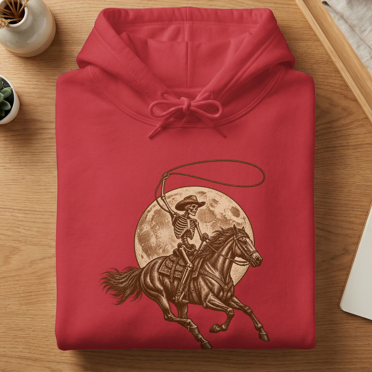 Red hoodie with skeleton cowboy riding a horse against a moon graphic.