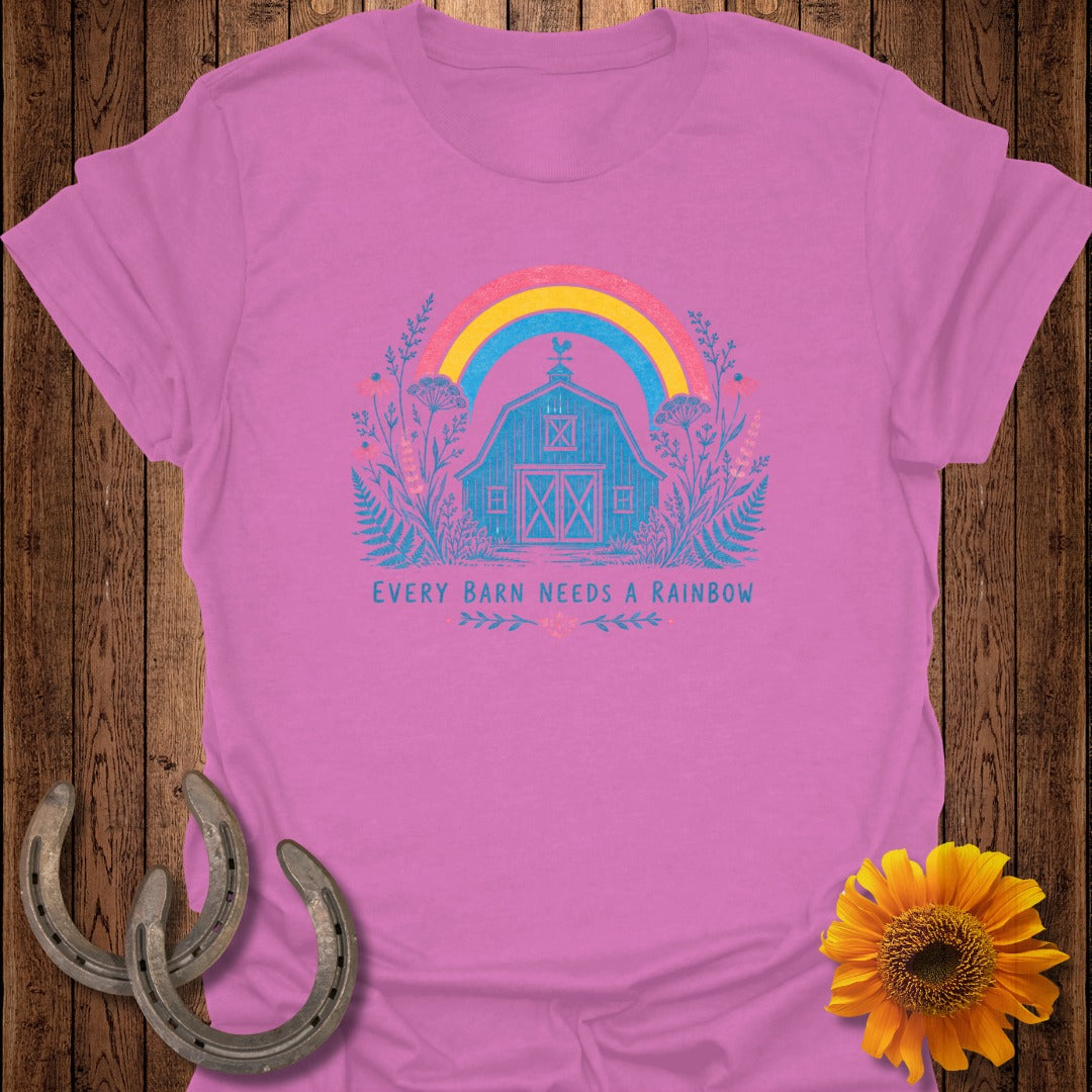 Pink t-shirt with blue barn and rainbow graphic and text "Every Barn Needs a Rainbow".