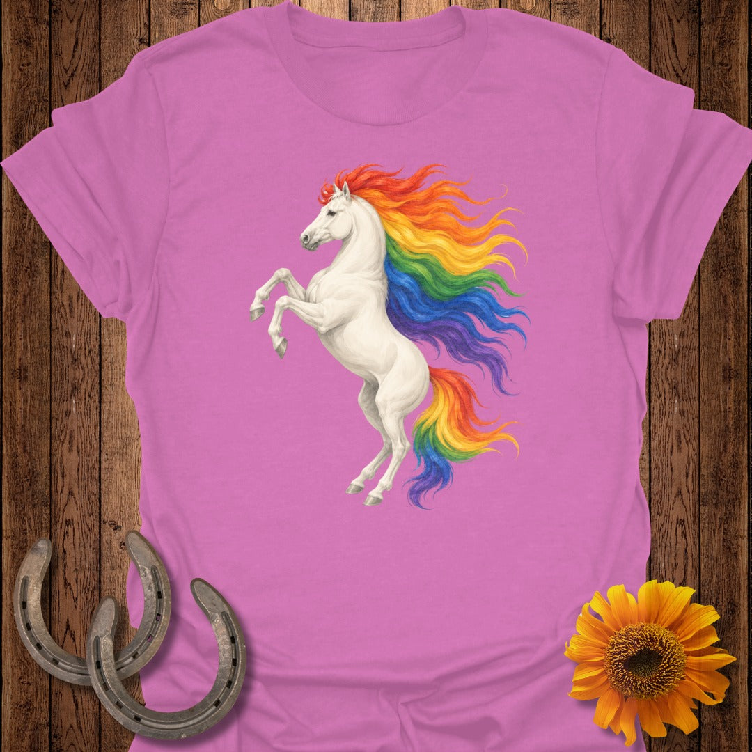 White unicorn with rainbow mane rearing up on pink t-shirt.