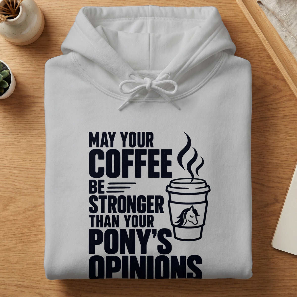 White hoodie with text "May your coffee be stronger than your pony's opinions" and coffee cup graphic.