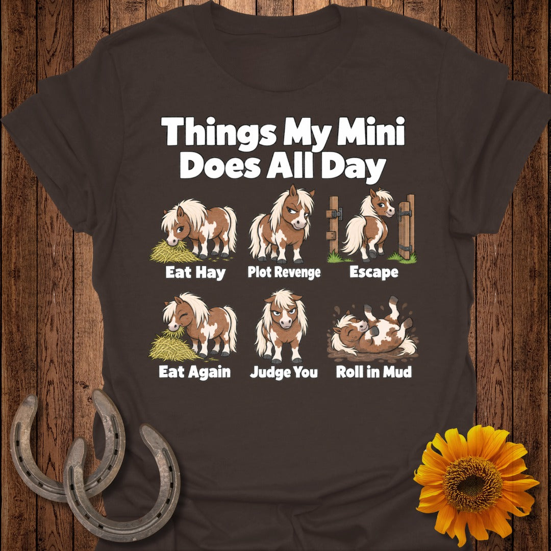 Brown t-shirt with cartoon ponies depicting "Eat Hay," "Plot Revenge," "Escape," "Eat Again," "Judge You," and "Roll in Mud."