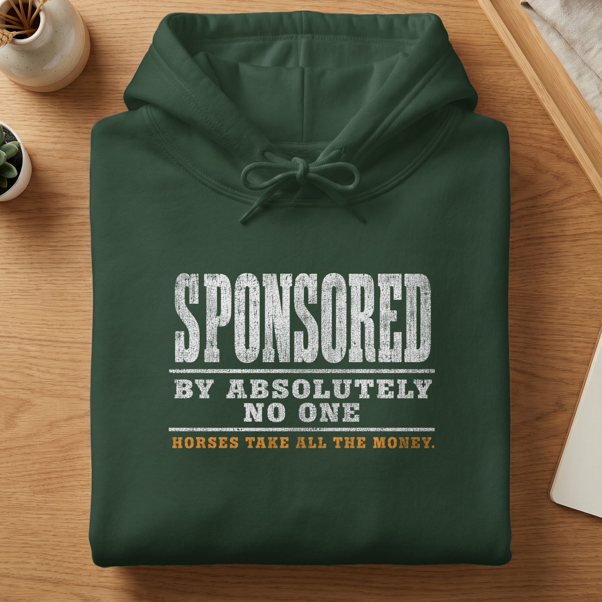 Dark green hoodie with text "SPONSORED BY ABSOLUTELY NO ONE HORSES TAKE ALL THE MONEY."