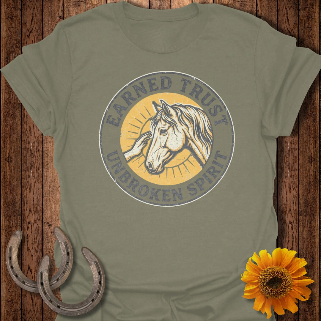 Olive green t-shirt with "EARNED TRUST UNBROKEN SPIRIT" circle logo and horse illustration.