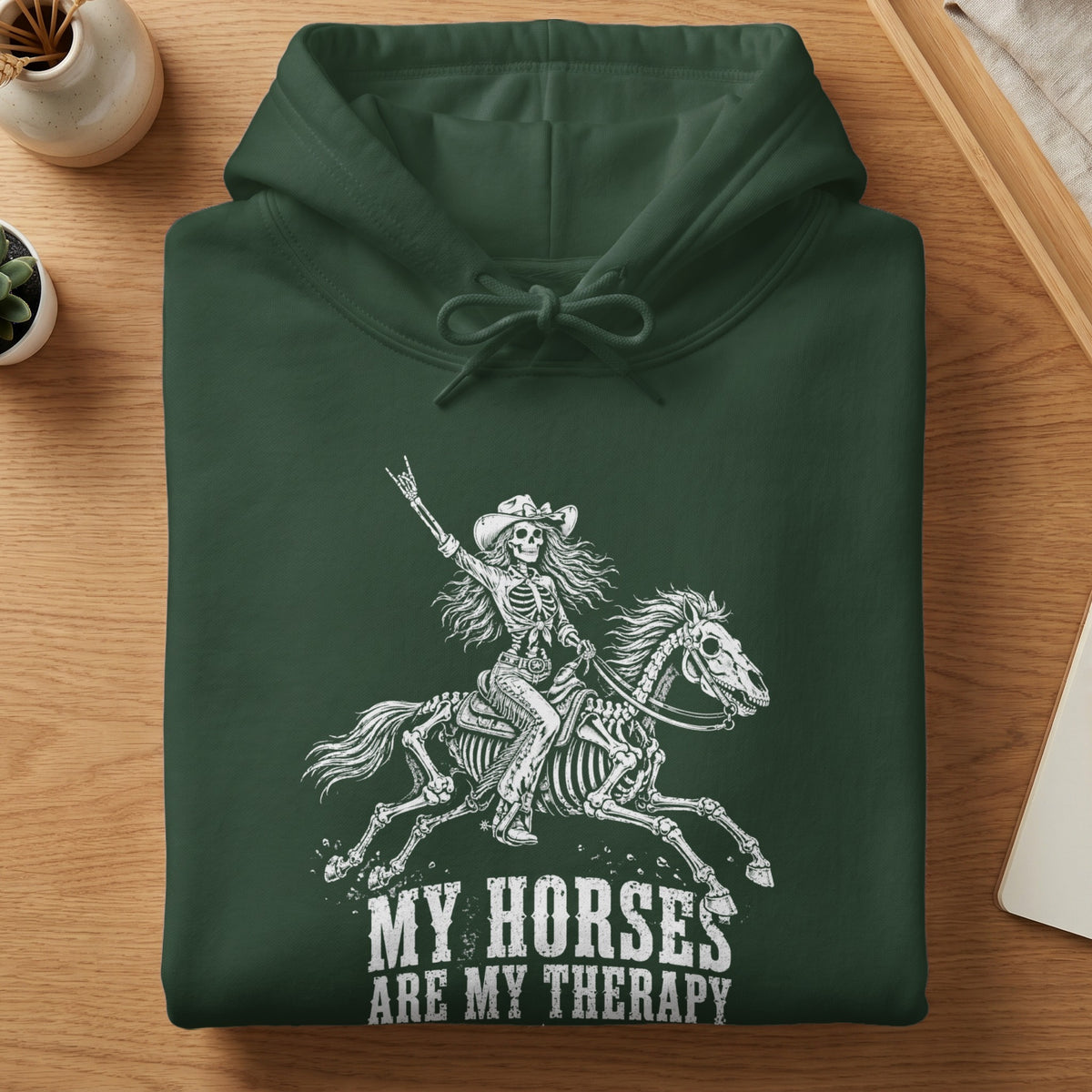 Dark green hoodie with skeleton rider on horse graphic and text "MY HORSES ARE MY THERAPY".