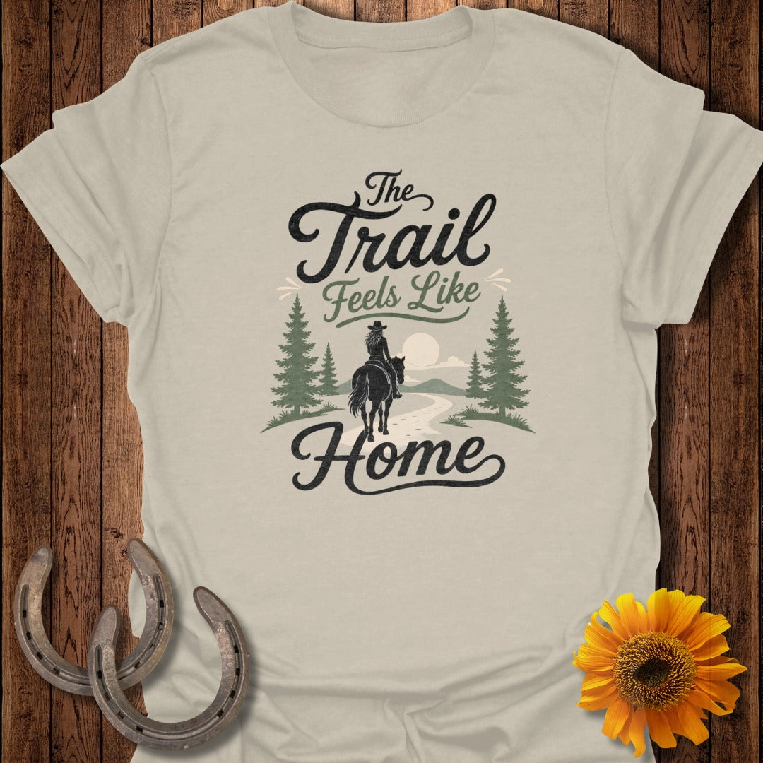 T-shirt graphic with "The Trail Feels Like Home" text and a rider on horseback.