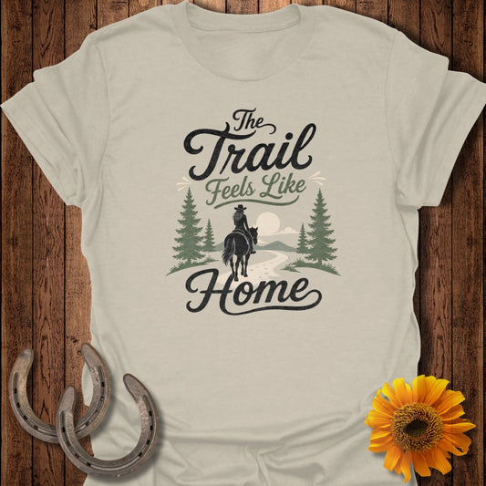 T-shirt graphic with "The Trail Feels Like Home" text and a rider on horseback.