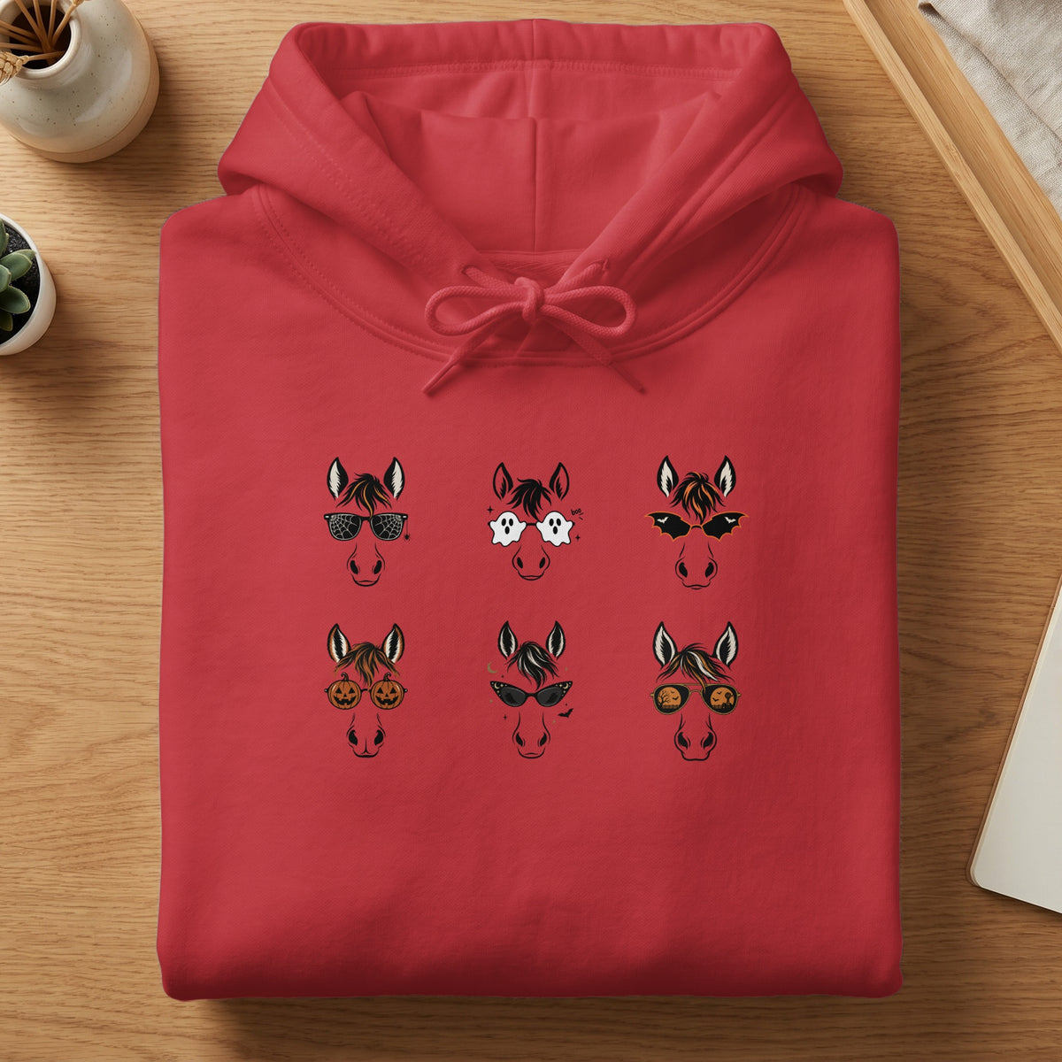 Red hoodie with six Halloween-themed horse heads printed on the front.