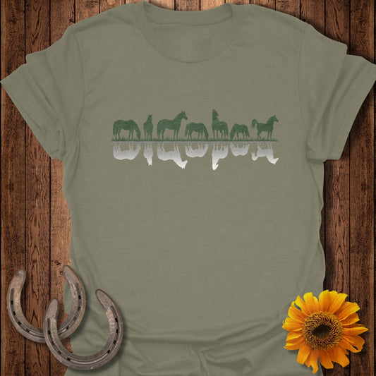 Green horses and reflections on a gray t-shirt with horseshoes and a sunflower.