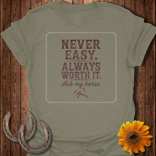 Never Easy. Always Worth It. Ask my horse. graphic on a tan t-shirt.
