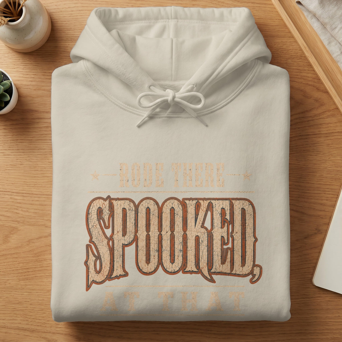 Cream hoodie with "RODE THERE SPOOKED AT THAT" text.