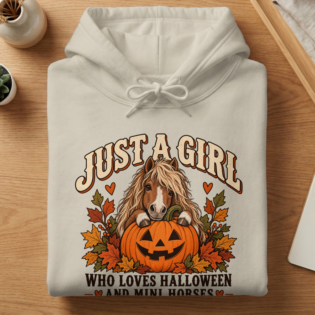 Cream hoodie with "Just a girl who loves Halloween and mini horses" text and graphics.