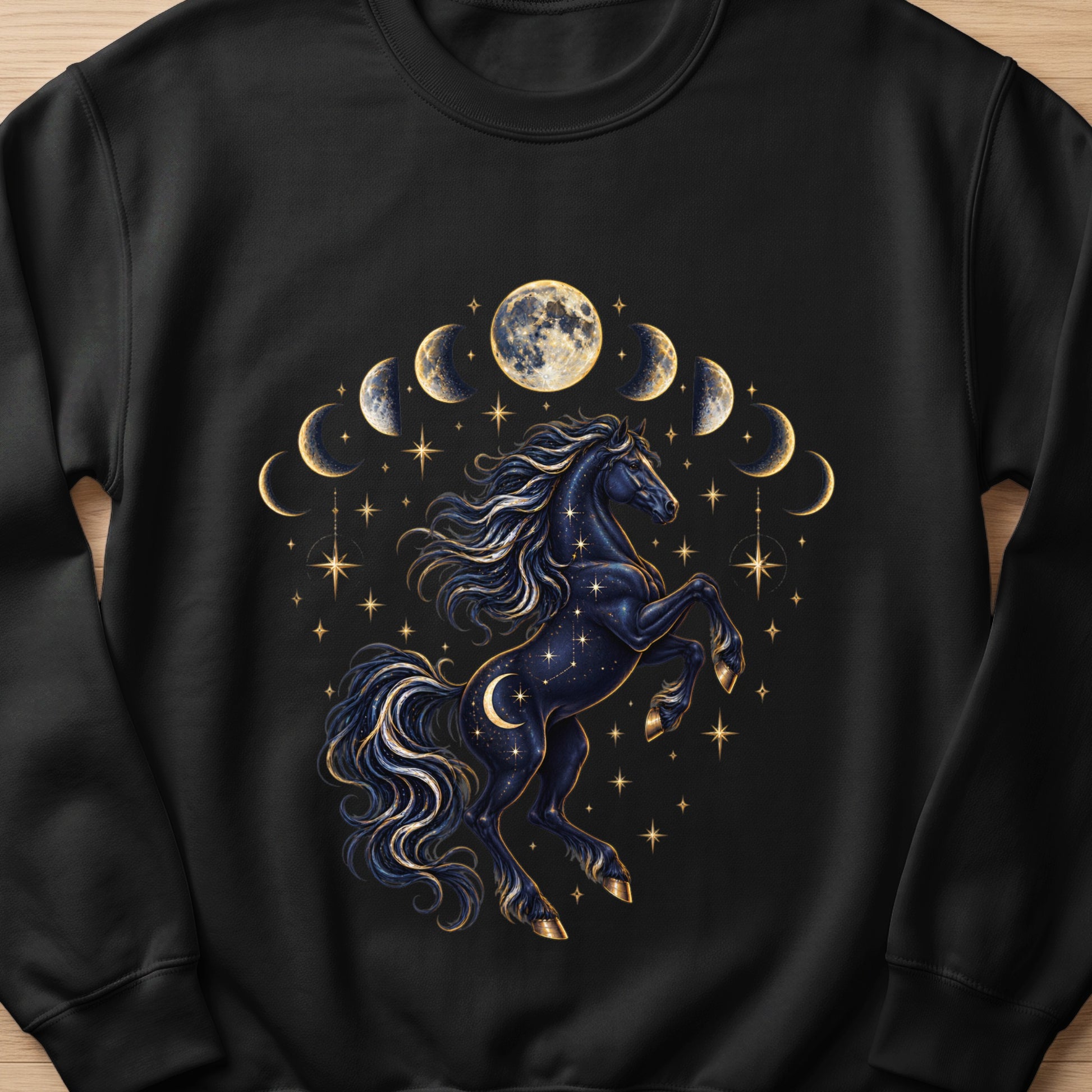 Black sweatshirt featuring a starry, crescent moon adorned horse with moon phases and stars.