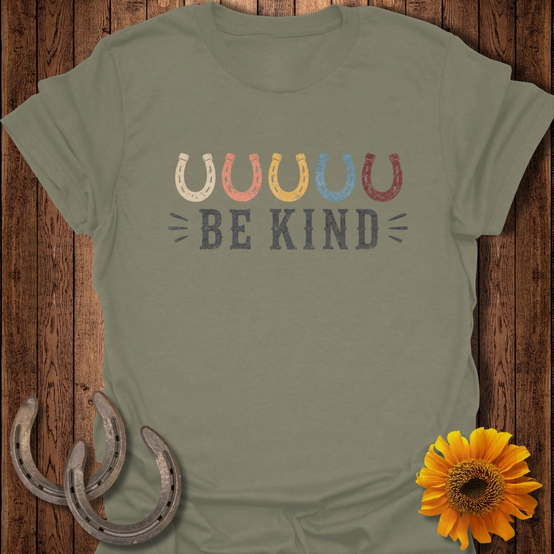 Green t-shirt with colorful horseshoe graphic and "BE KIND" text.