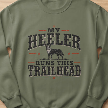 Green sweatshirt with graphic text "My Heeler Runs This Trailhead" and a dog.