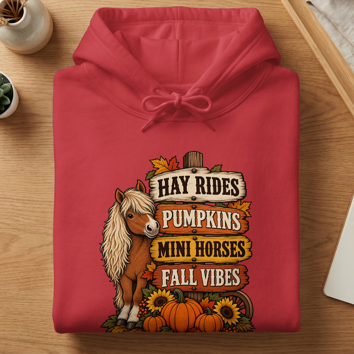 Red hoodie with fall graphic of a mini horse, pumpkins, and signs.