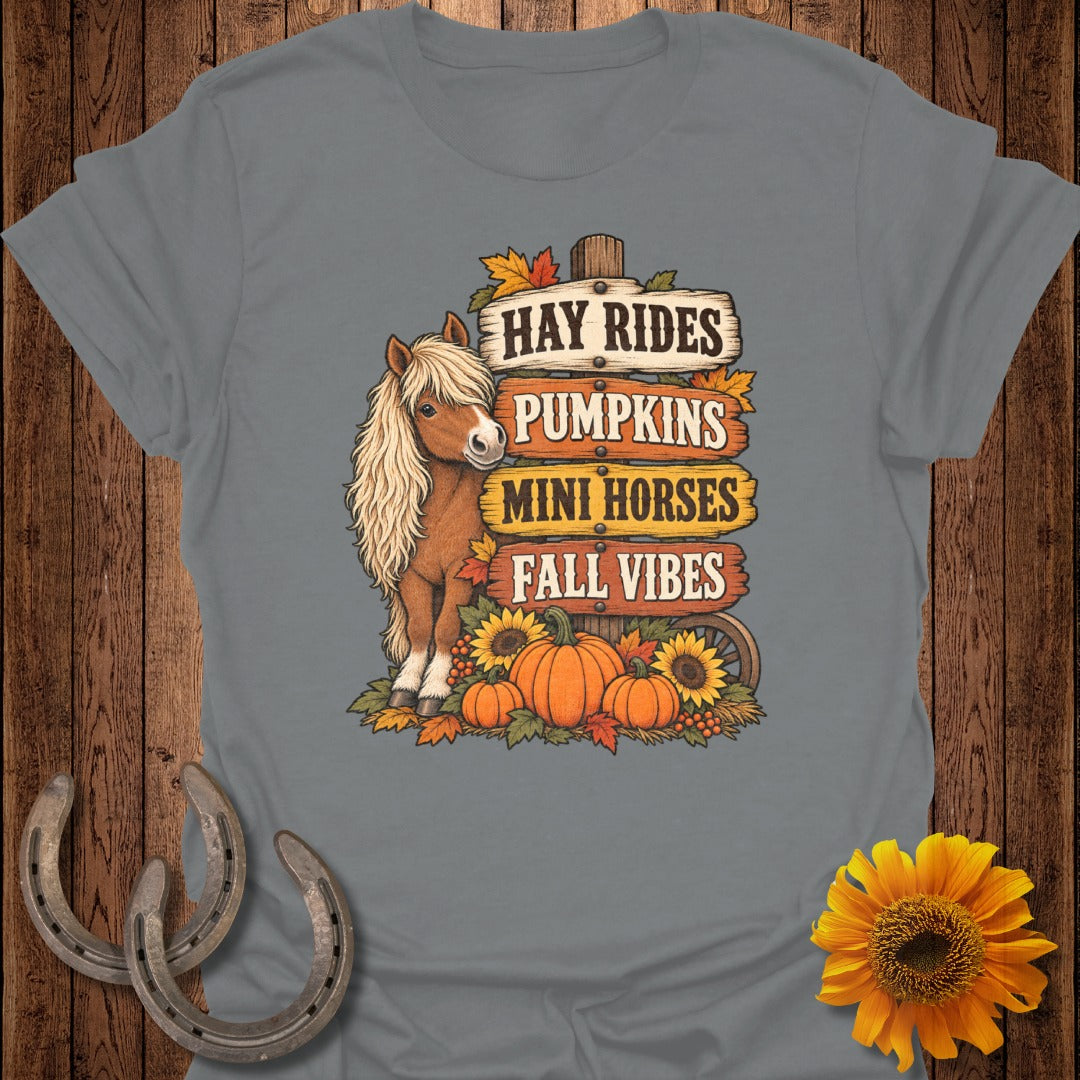 Mini horse, pumpkins, sunflowers, and signs saying "Hay Rides, Pumpkins, Mini Horses, Fall Vibes."