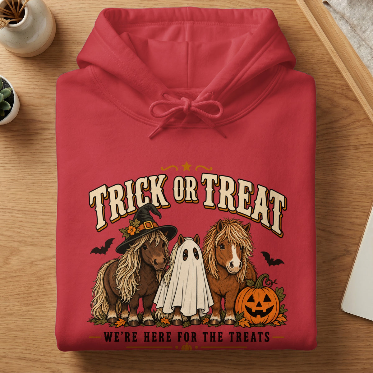 Red hoodie with a Halloween graphic featuring ponies and the text "Trick or Treat".