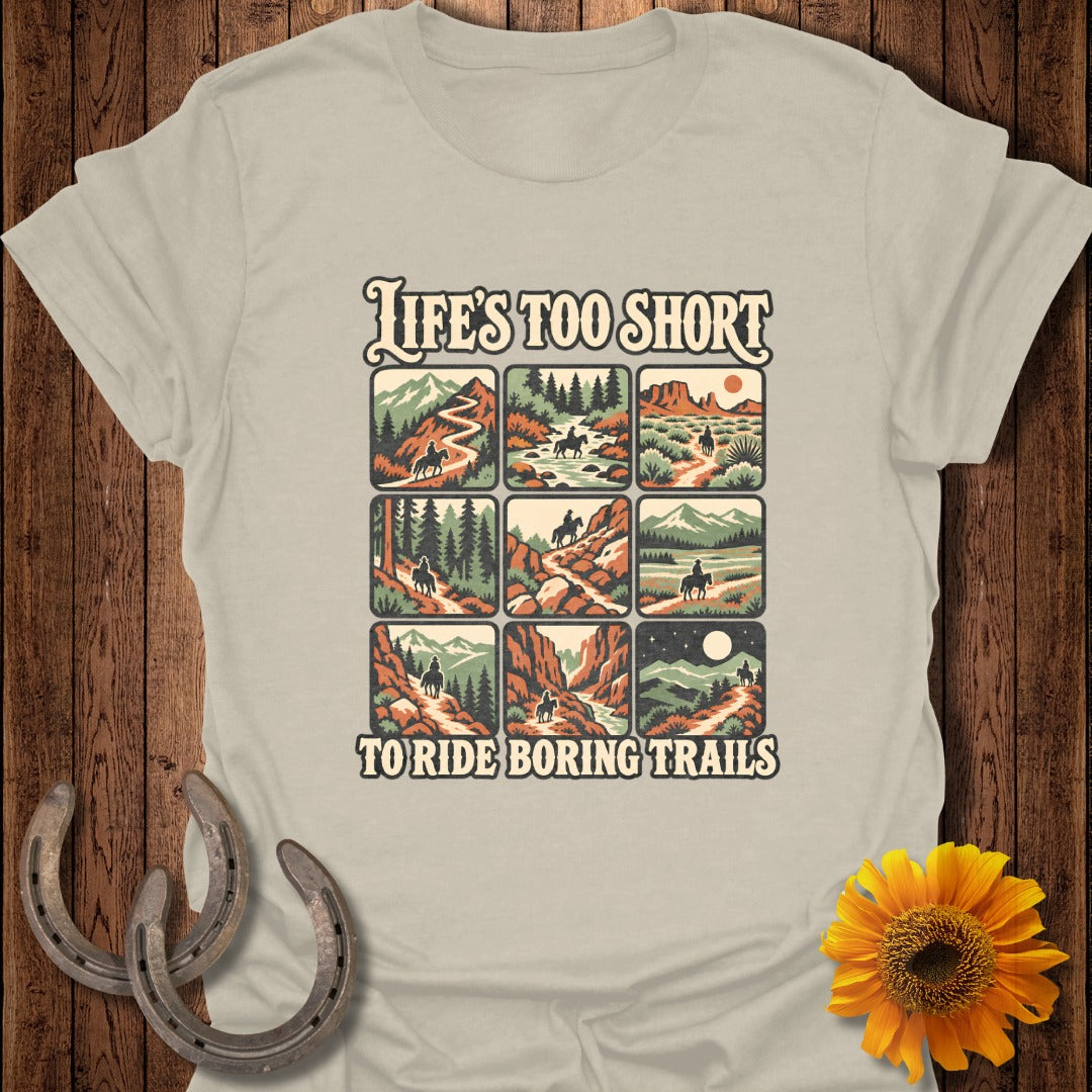 T-shirt graphic with nine scenes of people riding horses on various trails and the text "LIFE'S TOO SHORT TO RIDE BORING TRAILS".
