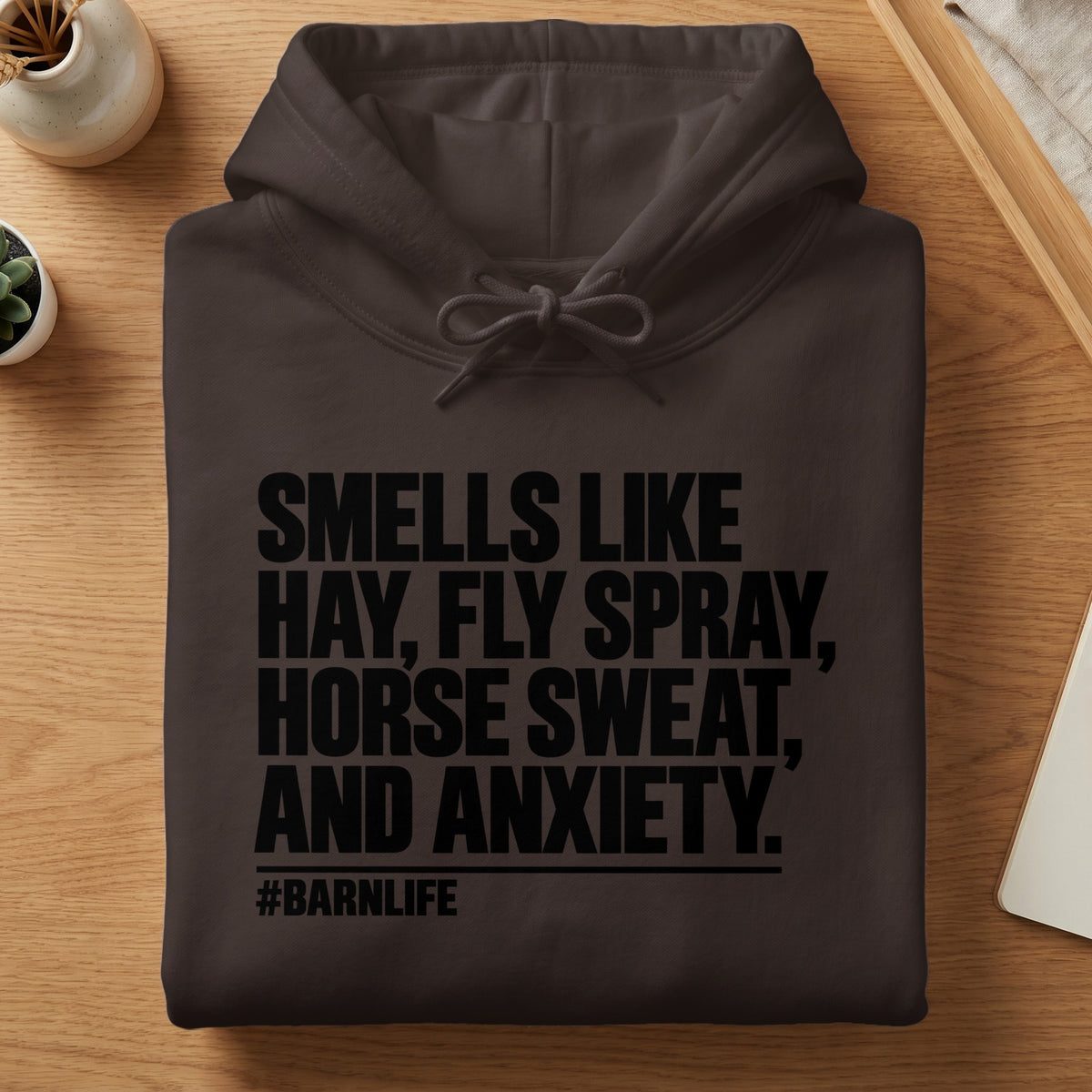 Brown hoodie with black text: "Smells like hay, fly spray, horse sweat, and anxiety. #barnlife"
