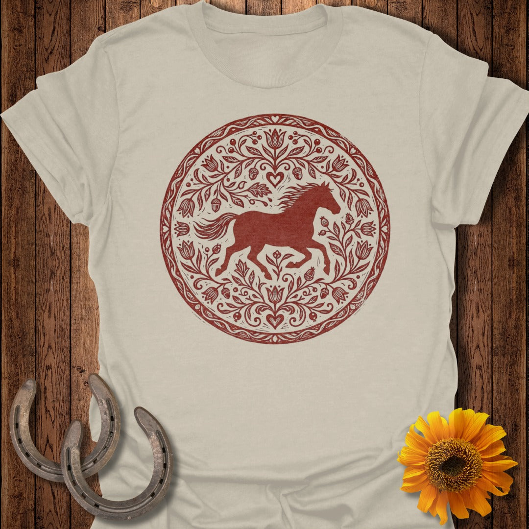 Beige t-shirt with a circular red horse and floral motif.