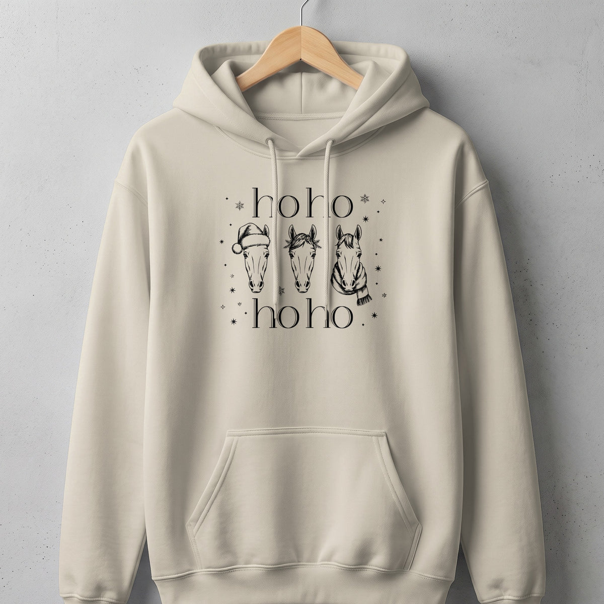 Cream hoodie with black graphic of three horses and "hoho" text.