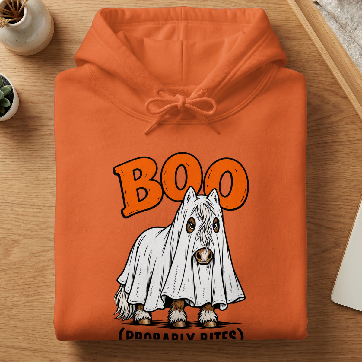 Orange hoodie with a Halloween ghost horse graphic that says "Boo (Probably Bites)".