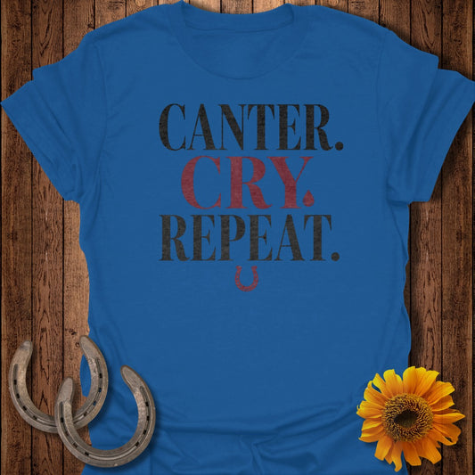 Blue t-shirt with "CANTER. CRY. REPEAT." text and horseshoe accents.