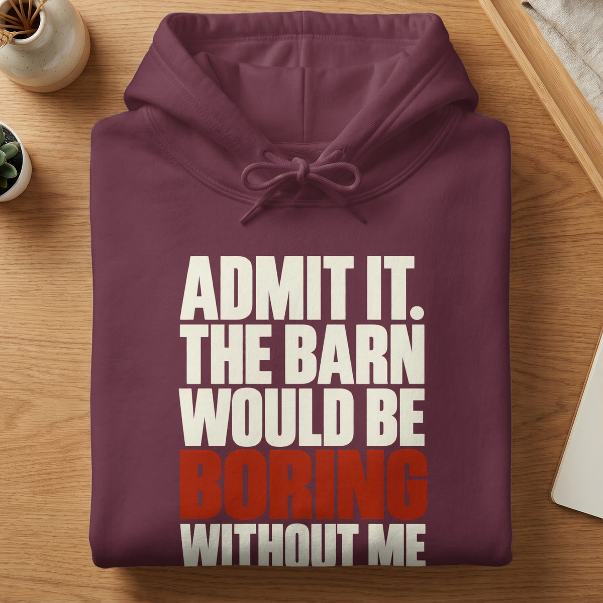 Folded maroon hoodie with the white and red text "ADMIT IT. THE BARN WOULD BE BORING WITHOUT ME."