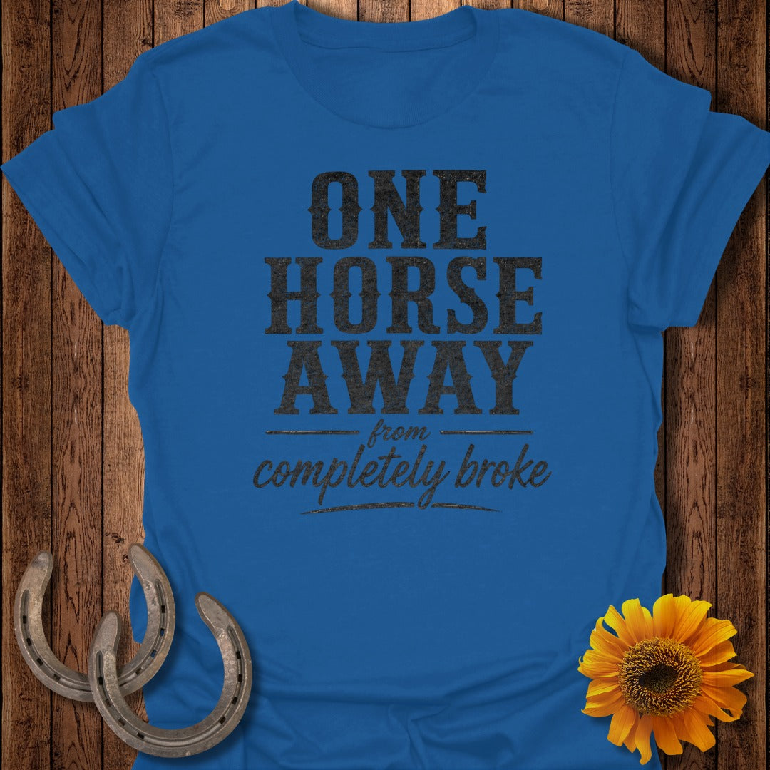 Blue t-shirt with "ONE HORSE AWAY from completely broke" text.