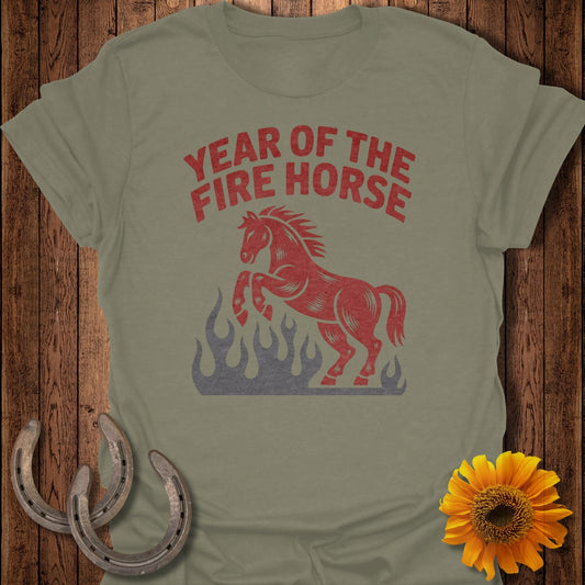 Red fire horse graphic with flames on a light green t-shirt.