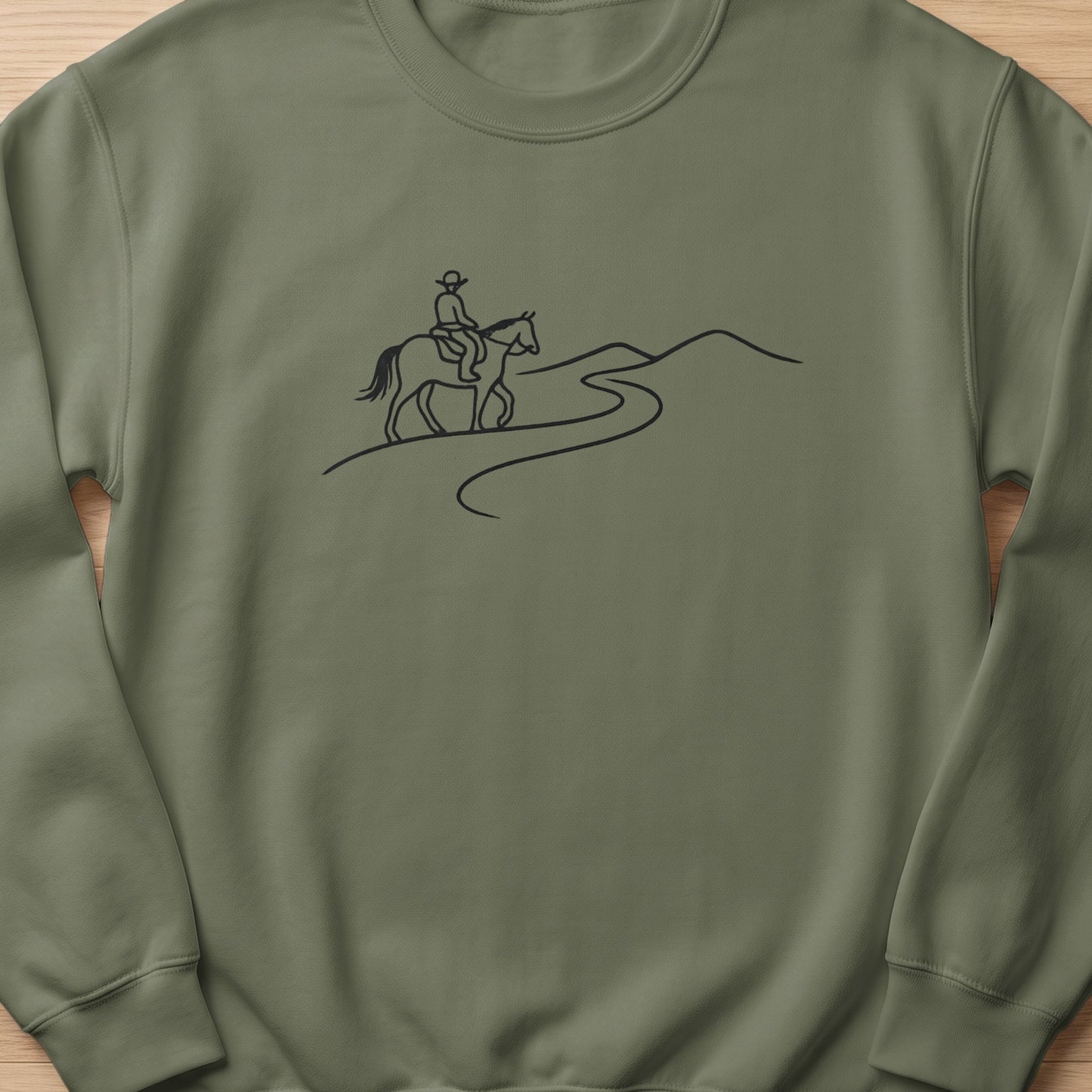 Line art of a person riding a horse on a winding path through hills.