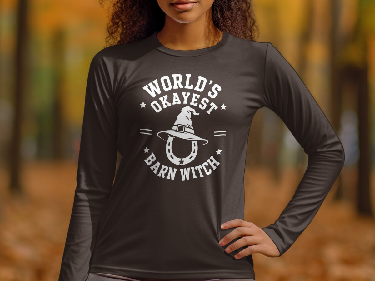 Dark grey long-sleeve shirt with white text and graphics: "World's Okayest Barn Witch."