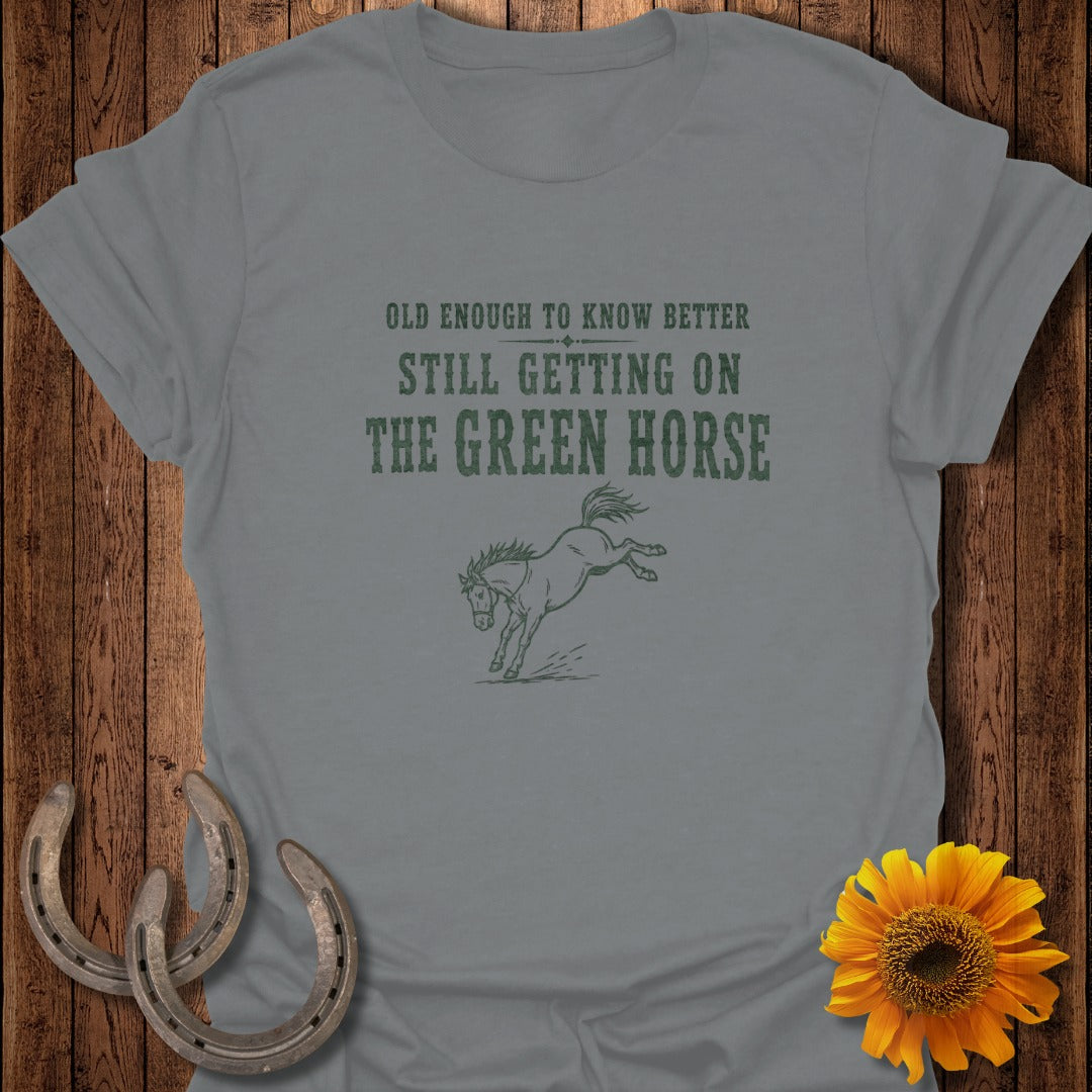 Grey t-shirt with "Old enough to know better, still getting on the green horse" and a horse illustration.