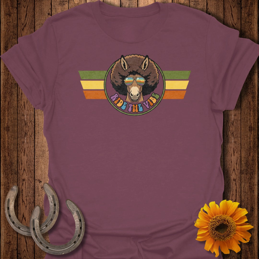 Donkey with afro and sunglasses, "Ride the Vibes" text, on burgundy t-shirt.