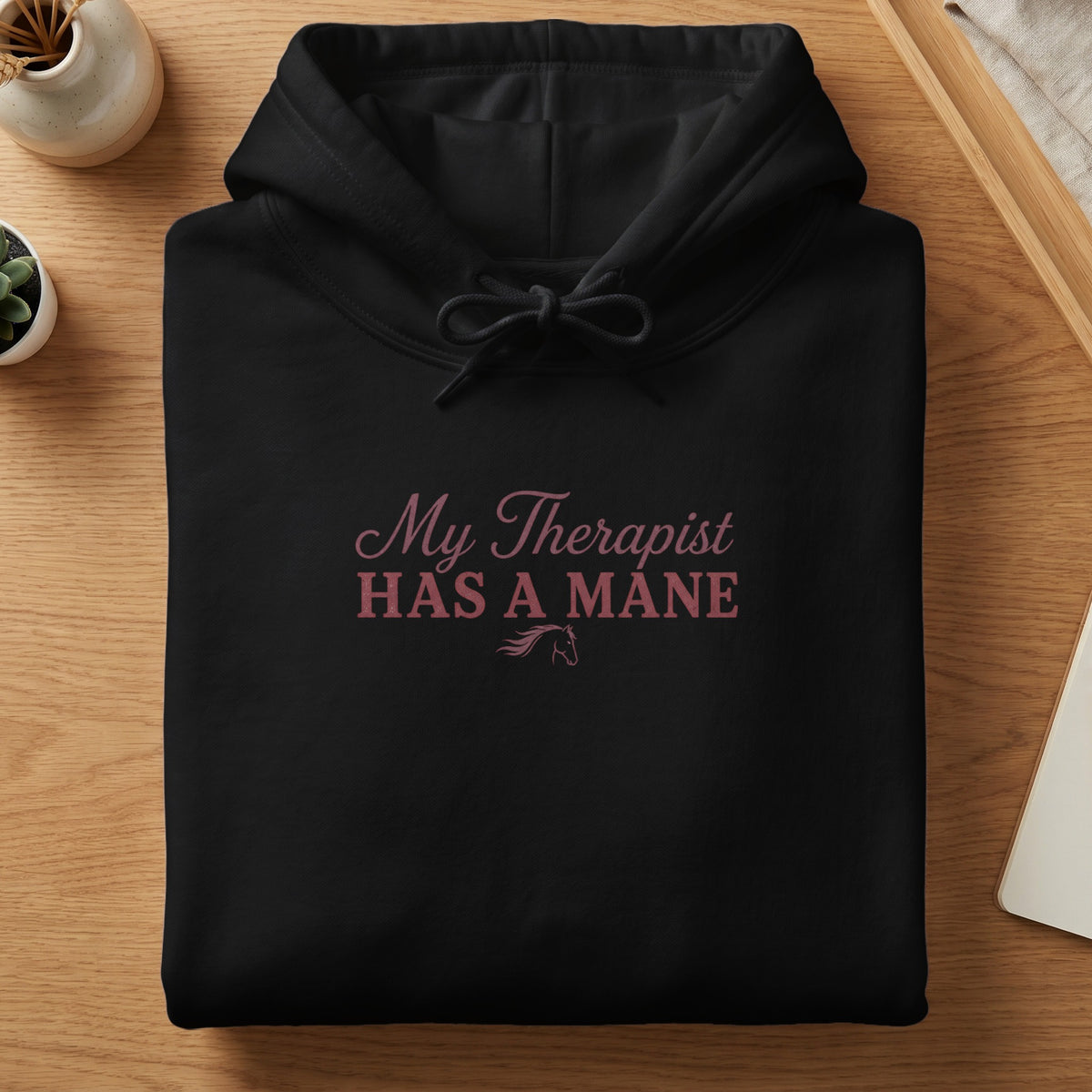 Black hoodie with pink text "My Therapist HAS A MANE" and horse graphic.