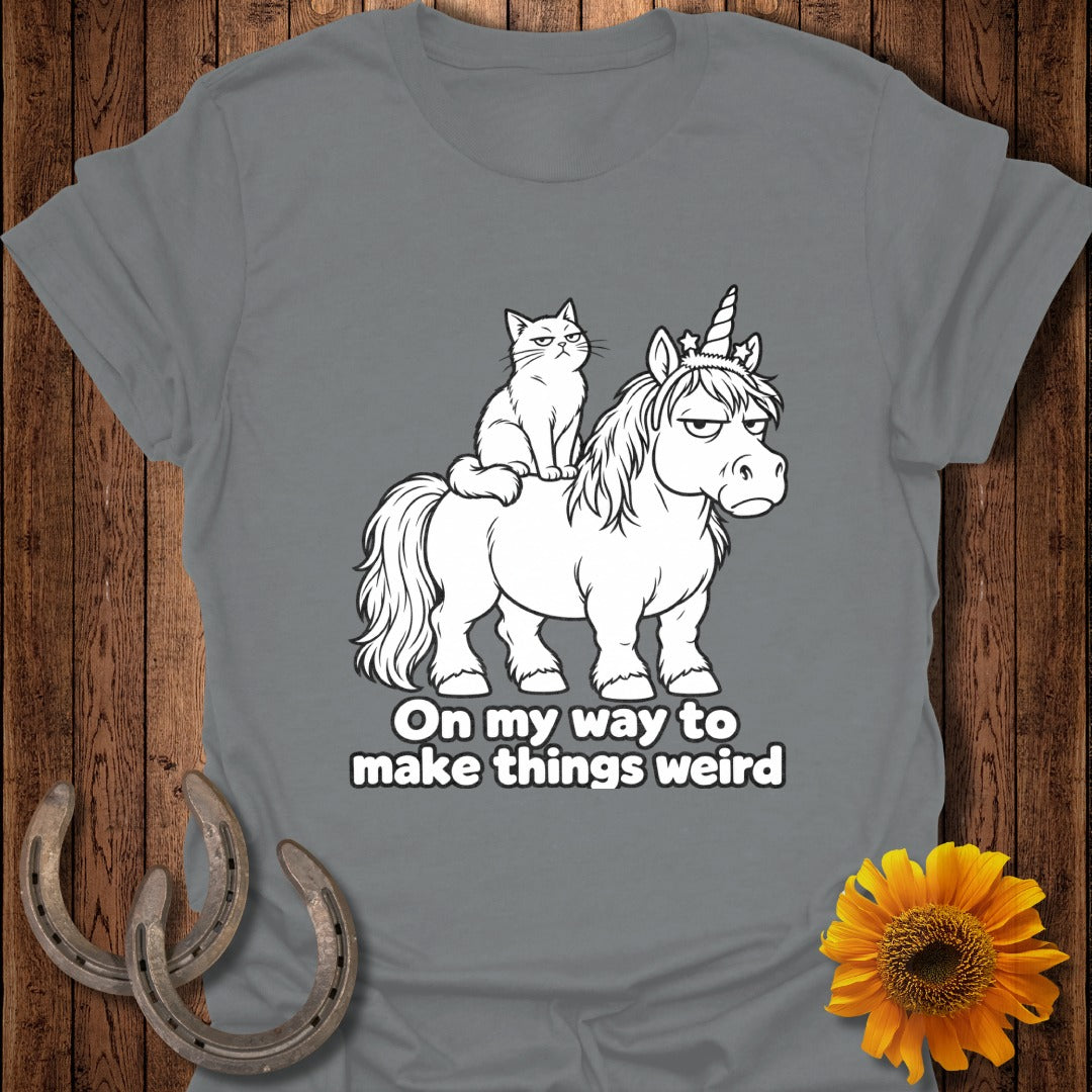 A gray t-shirt with a grumpy cat riding a grumpier unicorn and text reading On my way to make things weird.