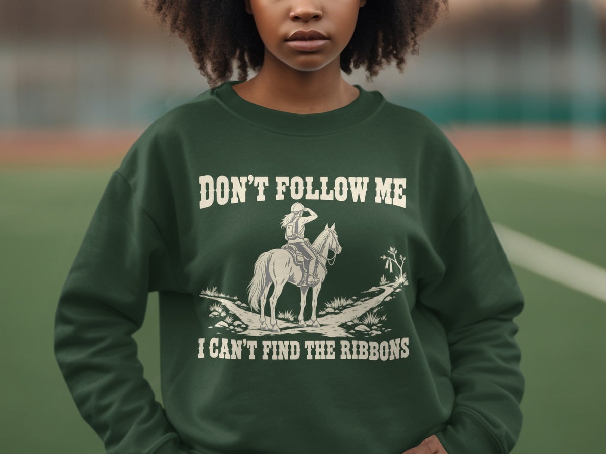 A person wearing a dark green crewneck sweatshirt featuring an equestrian graphic and text.