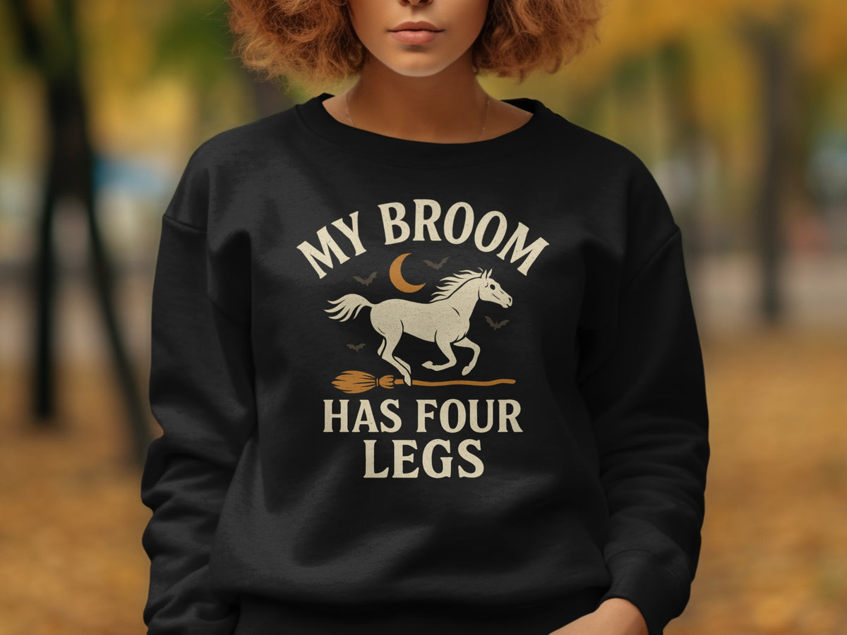 Black sweatshirt with "My Broom Has Four Legs" text and horse graphic.